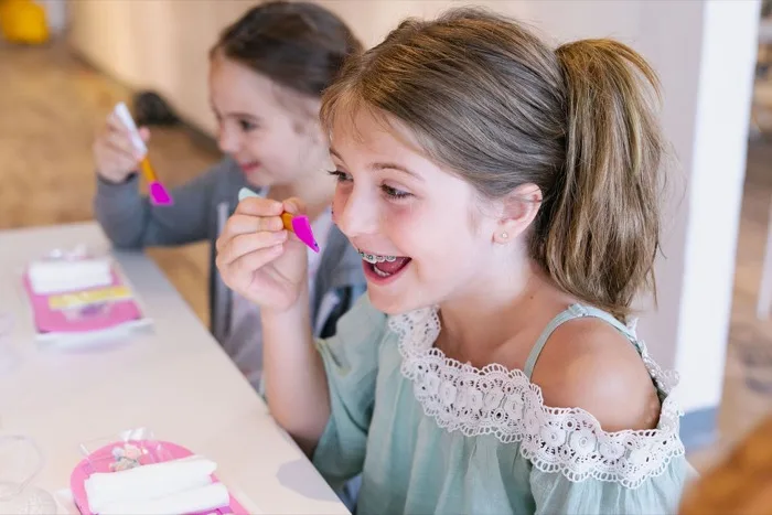 Two girls getting manicures together at a spa party